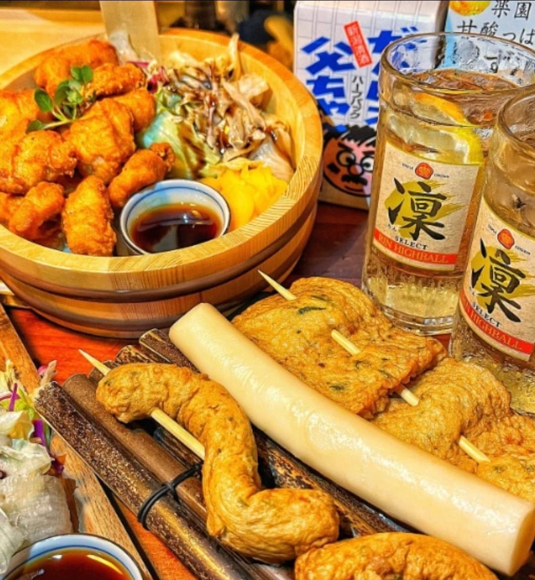 세종특별자치시 호려울로 철길부산집 세종보람점 요리주점. 다찌석 1인 혼술 차림으로 바삭한 가라아게와 쫄깃한 가래떡, 어묵 꼬치, 레몬 하이볼이 나무 테이블 조명 아래 놓인 상황.