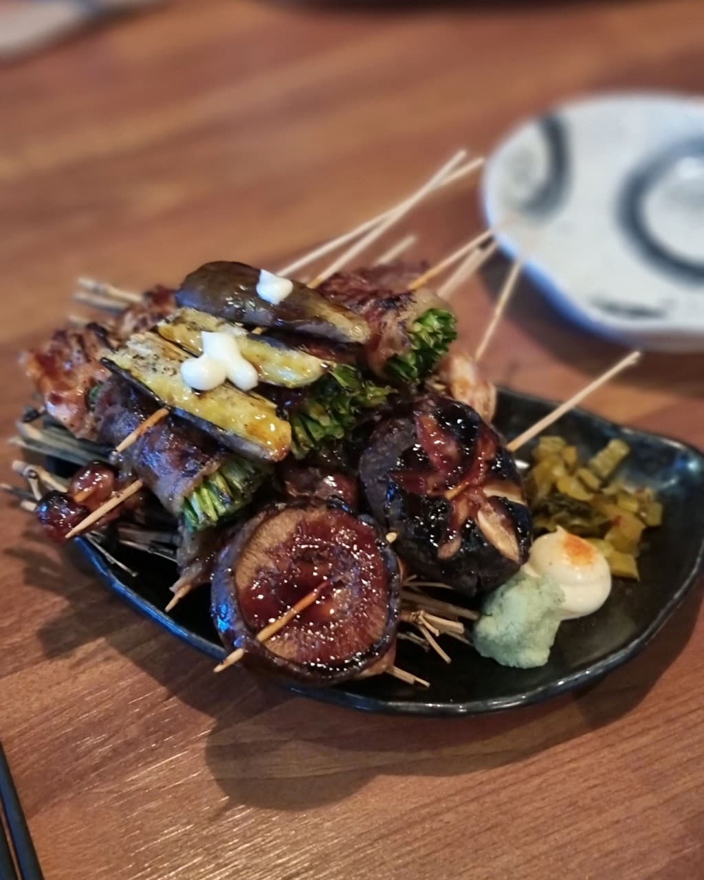 세종특별자치시 나성북1로 이자카야탕 세종점 이자카야 다찌석 조명 아래 윤기 나는 표고버섯과 고기말이 꼬치가 정갈하게 담긴 1인 혼술 차림