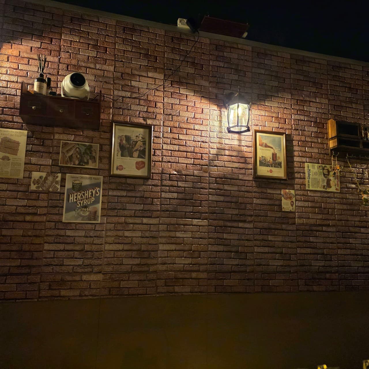 인천광역시 남동구 곁혼술바 구월점 인천 바(Bar) 내부. 붉은 벽돌 벽면에 빈티지 포스터와 전구색 조명이 비추는 1인 혼술 공간.