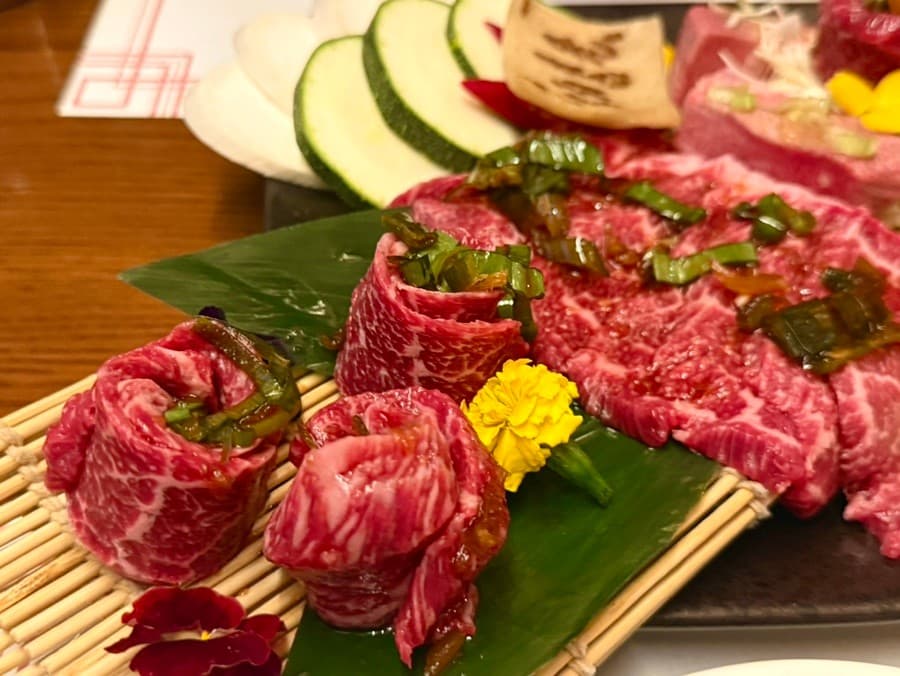 경상북도 경주시 모모치준 황남 경북 이자카야 다찌석 1인 혼술. 따뜻한 조명 아래 선홍빛 마블링의 생소고기와 채소가 나무 받침에 차려진 식사 상황.