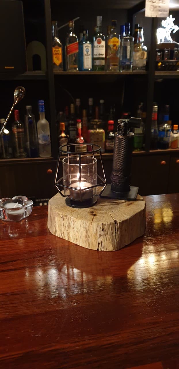 경상북도 안동시 레옹 정하점 경북 바(Bar) 다찌석. 원목 받침대 위 촛불 조명과 다양한 술병이 진열된 선반을 배경으로 구성된 1인 혼술 공간.